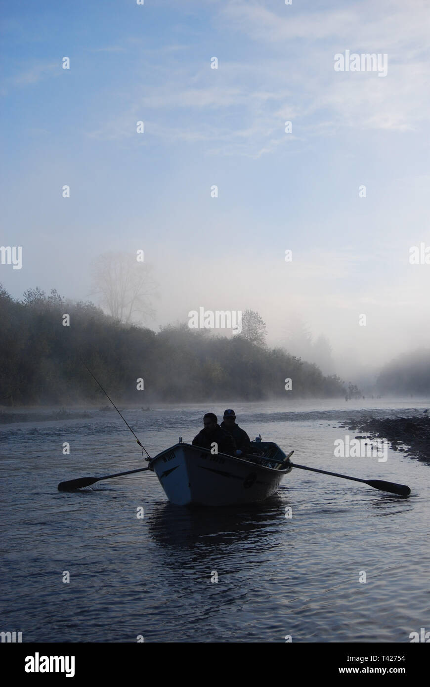 Salmon fishermen in a drift boat rowing on the Humptulips River on the Olympic Peninsulas in western Washington State,USA. Stock Photo