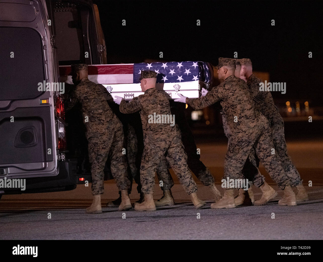 A United States Marine Corps carry team participates in the Dignified Transfer of the transfer case containing the remains of United States Marine Corps Staff Sergeant Christopher A. Slutman at Dover Air Force Base in Dover, Delaware on April 11, 2019.  He died as the result of a road-side bomb in Afghanistan on April 8, 2019.  Staff Sergeant Slutman, a decorated 15 year veteran of the Fire Department of New York (FDNY), was married and had three children. Credit: Ron Sachs / CNP (RESTRICTION: NO New York or New Jersey Newspapers or newspapers within a 75 mile radius of New York City) | usage  Stock Photo