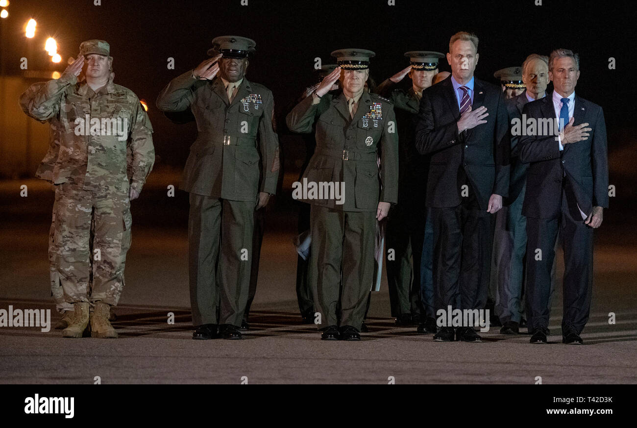 Front row, from left to right: United States Air Force Colonel Matthew Jones, 436th Airlift Wing, Vice Commander; Sergeant Major of the US Marine Corps Ronald Green; US Marine Corps General Robert B. Neller, Commandant of the Marine Corps; Acting United States Secretary of Defense Patrick M. Shanahan; and Governor John Carney (Democrat of Delaware); and US Senator Tom Carper (Democrat of Delaware), salute as a US Marine Corps carry team participates in the Dignified Transfer of the transfer case containing the remains of US Marine Corps Staff Sergeant Christopher A. Slutman at Dover Air Force  Stock Photo