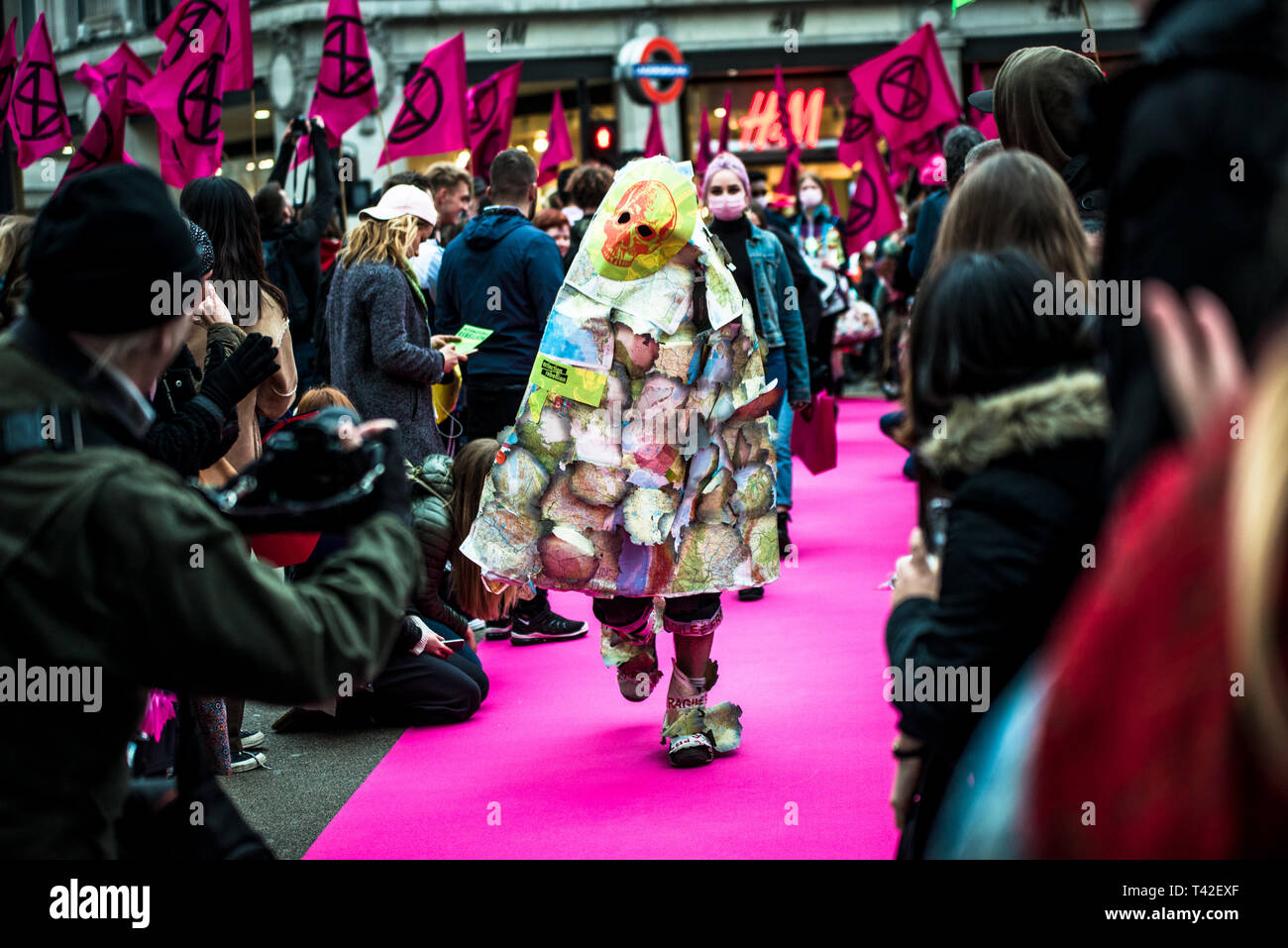 London, Londo, UK. 12th Apr, 2019. An activist seen showcasing during the event.The Extinction Rebellion Fashion Action group went to Oxford Circus to a standstill by staging a creative and symbolic catwalk titled Fashion: Circus of Excess. The objective is to raise the alarm about the role fashion consumption plays in fuelling the Climate and Ecological emergency. The fashion industry is set to consume a quarter of the world's carbon budget by 2050 in clothing production. Credit: Brais G. Rouco/SOPA Images/ZUMA Wire/Alamy Live News Stock Photo