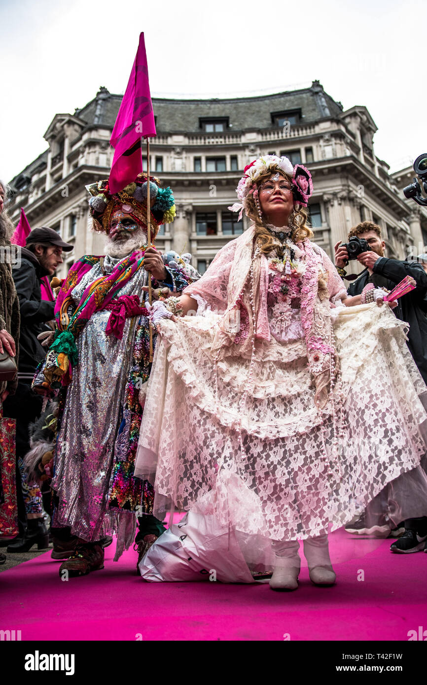 London, Londo, UK. 12th Apr, 2019. Activists are seen showcasing during the event.The Extinction Rebellion Fashion Action group went to Oxford Circus to a standstill by staging a creative and symbolic catwalk titled Fashion: Circus of Excess. The objective is to raise the alarm about the role fashion consumption plays in fuelling the Climate and Ecological emergency. The fashion industry is set to consume a quarter of the world's carbon budget by 2050 in clothing production. Credit: Brais G. Rouco/SOPA Images/ZUMA Wire/Alamy Live News Stock Photo