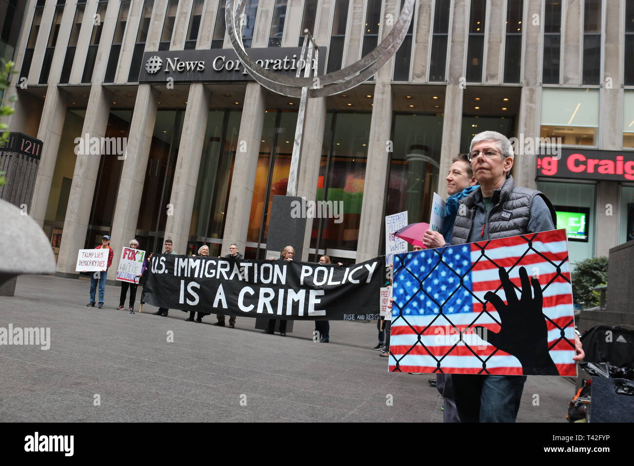 People seen holding various Pro-Immigration signs during a demonstration outside FOX News Office on 6th Avenue in New York City to call out FOX News’s anti-Immigration news Coverage. Stock Photo