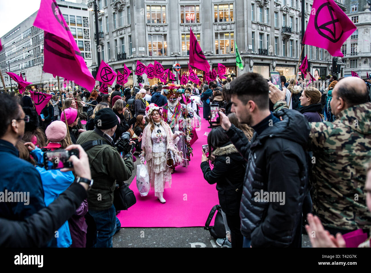 London, UK. 12th Apr, 2019. Activists seen showcasing outfits during the Extinction Rebellion fashion show in London. The Extinction Rebellion Fashion Action group brought Oxford Circus to a standstill by staging a creative and symbolic catwalk titled Fashion: Circus of Excess. The objective is to raise the alarm about the role fashion consumption plays in fuelling the Climate and Ecological emergency. The fashion industry is set to consume a quarter of the world's carbon budget by 2050 in clothing production. Credit: SOPA Images Limited/Alamy Live News Stock Photo