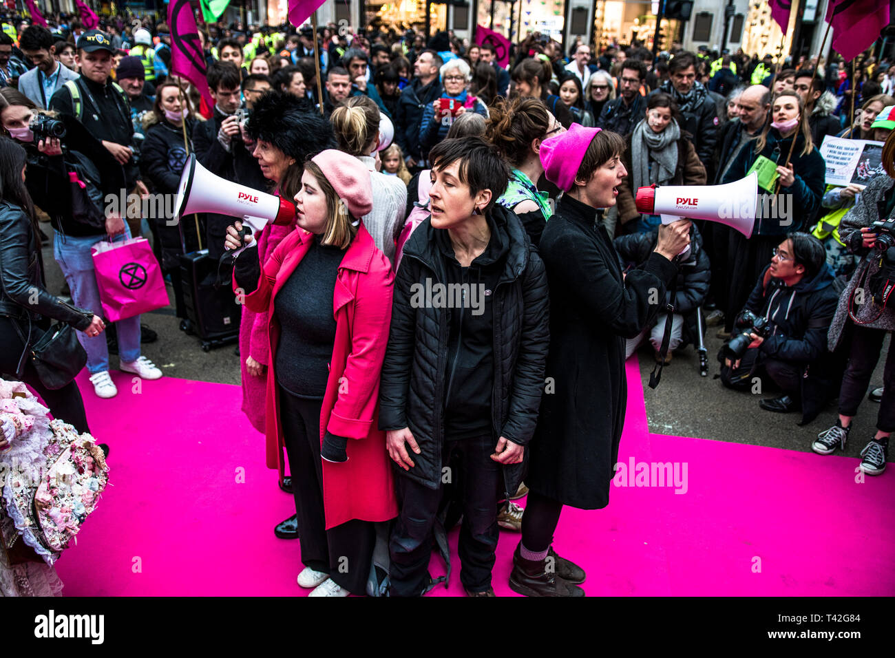 London, UK. 12th Apr, 2019. Activist seen singing during the Extinction Rebellion fashion show in London. The Extinction Rebellion Fashion Action group brought Oxford Circus to a standstill by staging a creative and symbolic catwalk titled Fashion: Circus of Excess. The objective is to raise the alarm about the role fashion consumption plays in fuelling the Climate and Ecological emergency. The fashion industry is set to consume a quarter of the world's carbon budget by 2050 in clothing production. Credit: SOPA Images Limited/Alamy Live News Stock Photo