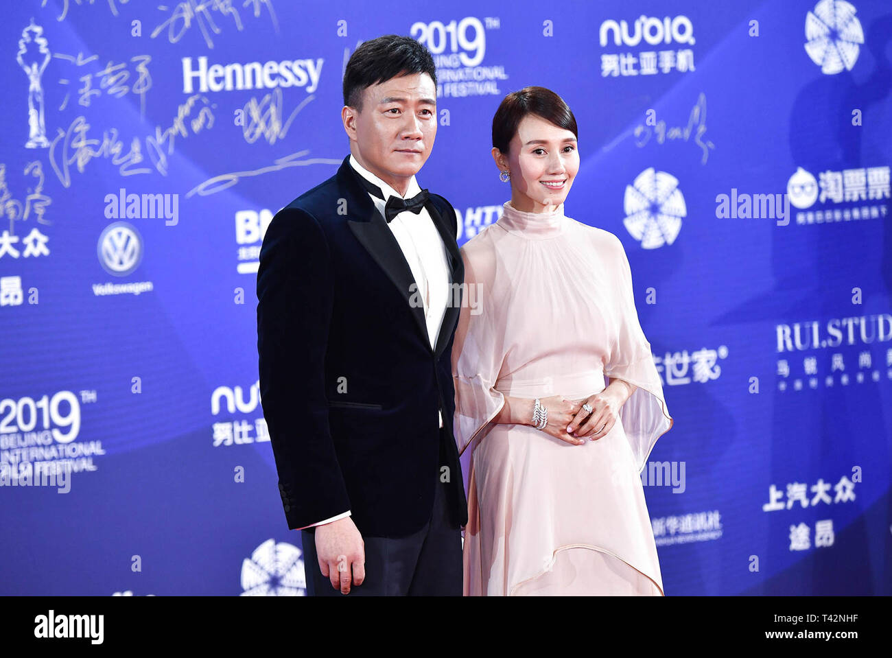 Beijing, China. 13th Apr, 2019. Actor Hu Jun (L) and actress Yuan Quan of the film 'Composer' pose for photos on the red carpet for the opening ceremony of the ninth Beijing International Film Festival in Beijing, capital of China, April 13, 2019. Credit: Liu Jinhai/Xinhua/Alamy Live News Stock Photo