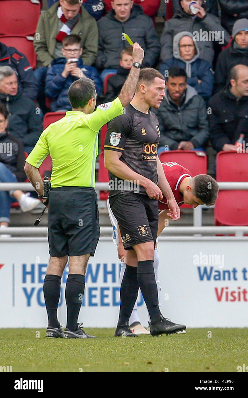 NORTHAMPTON, ENGLAND. 12th April. Referee Paul Marsden shows a yellow card to Mansfield Town's Matt Preston during the second half of the Sky Bet League 2 match between Northampton Town and Mansfield Town at the PTS Academy Stadium, Northampton on Saturday 13th April 2019. (Credit: John Cripps | MI News)  Editorial use only, license required for commercial use. No use in betting, games or a single club/league/player publications. Photograph may only be used for newspaper and/or magazine editorial purposes. May not be used for publications involving 1 player, 1 club or 1 competition without wri Stock Photo