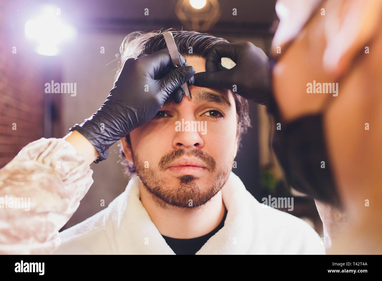 Closeup of process of threading procedure in barber shop. Professional