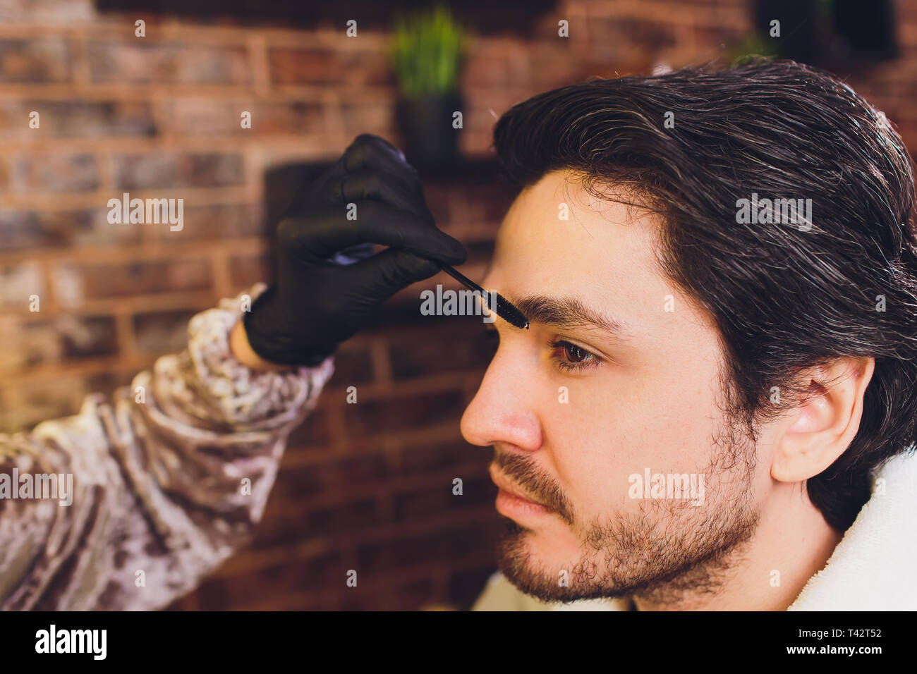 Closeup of process of threading procedure in barber shop. Professional