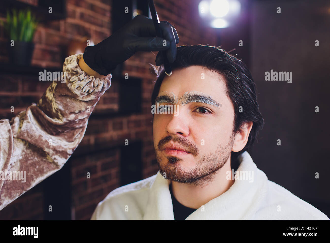 Closeup of process of threading procedure in barber shop. Professional