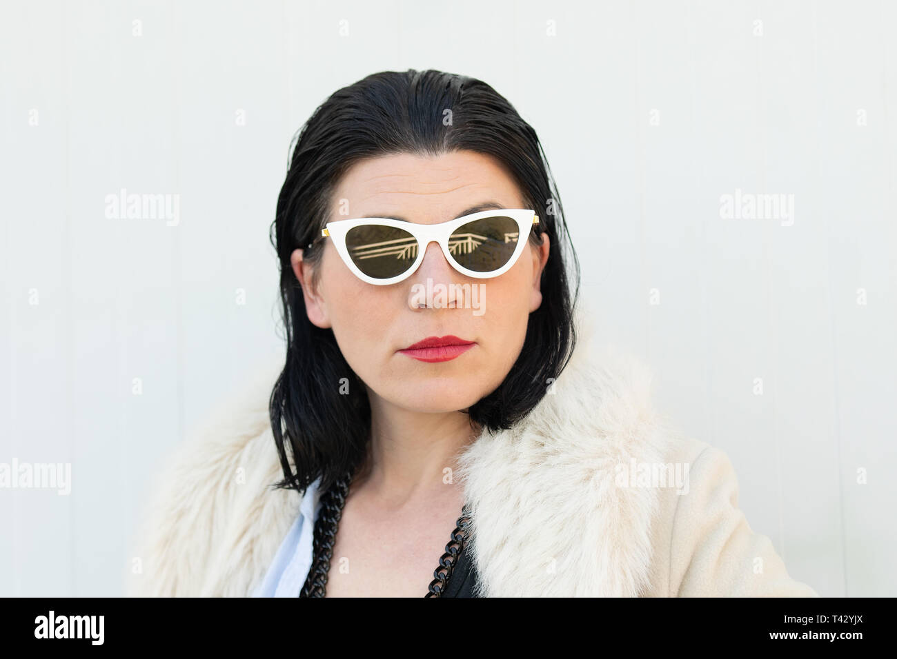 Portrait of a female model posing with white sunglasses Stock Photo Alamy