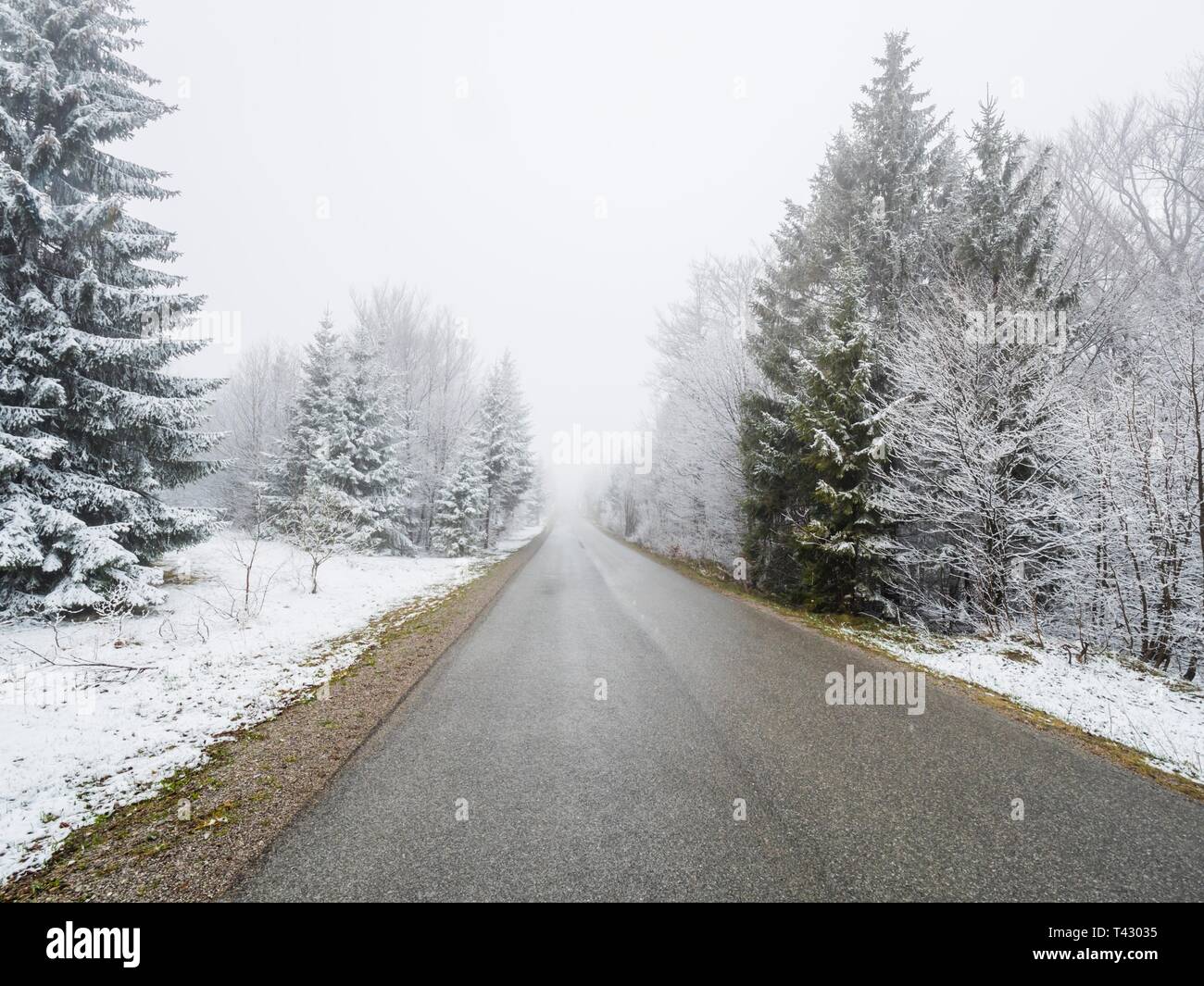 Sparse Snow Sparse snow in countryside with empty asphalt road in center centered ...