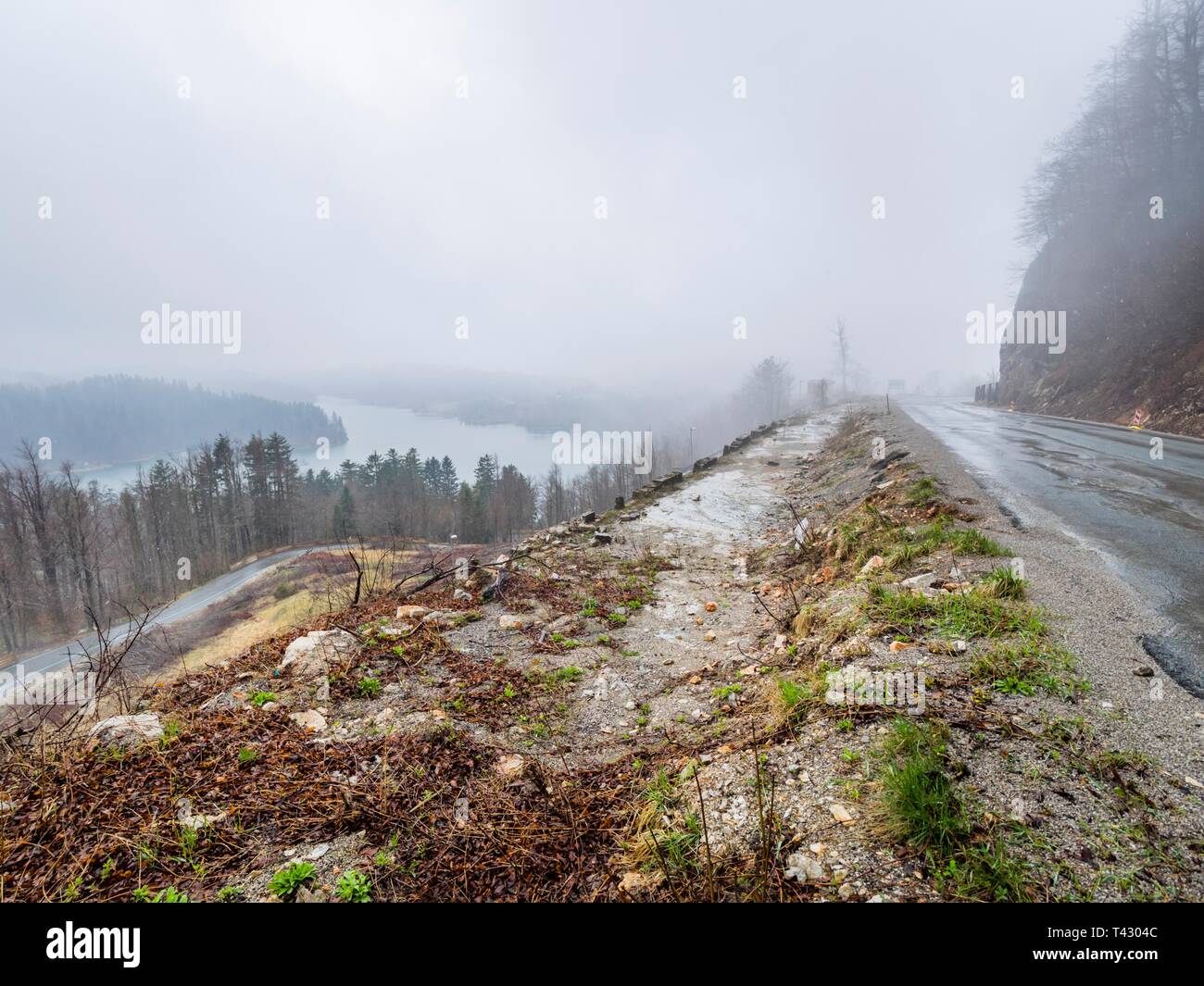 Remains of old road Lujzijana next to current one atop Lokve lake in Croatia Stock Photo