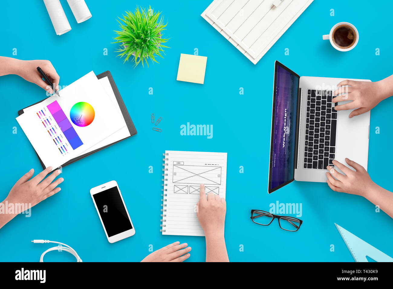 Development team work on user interface web project. Concept of work space. Top view scene. Stock Photo