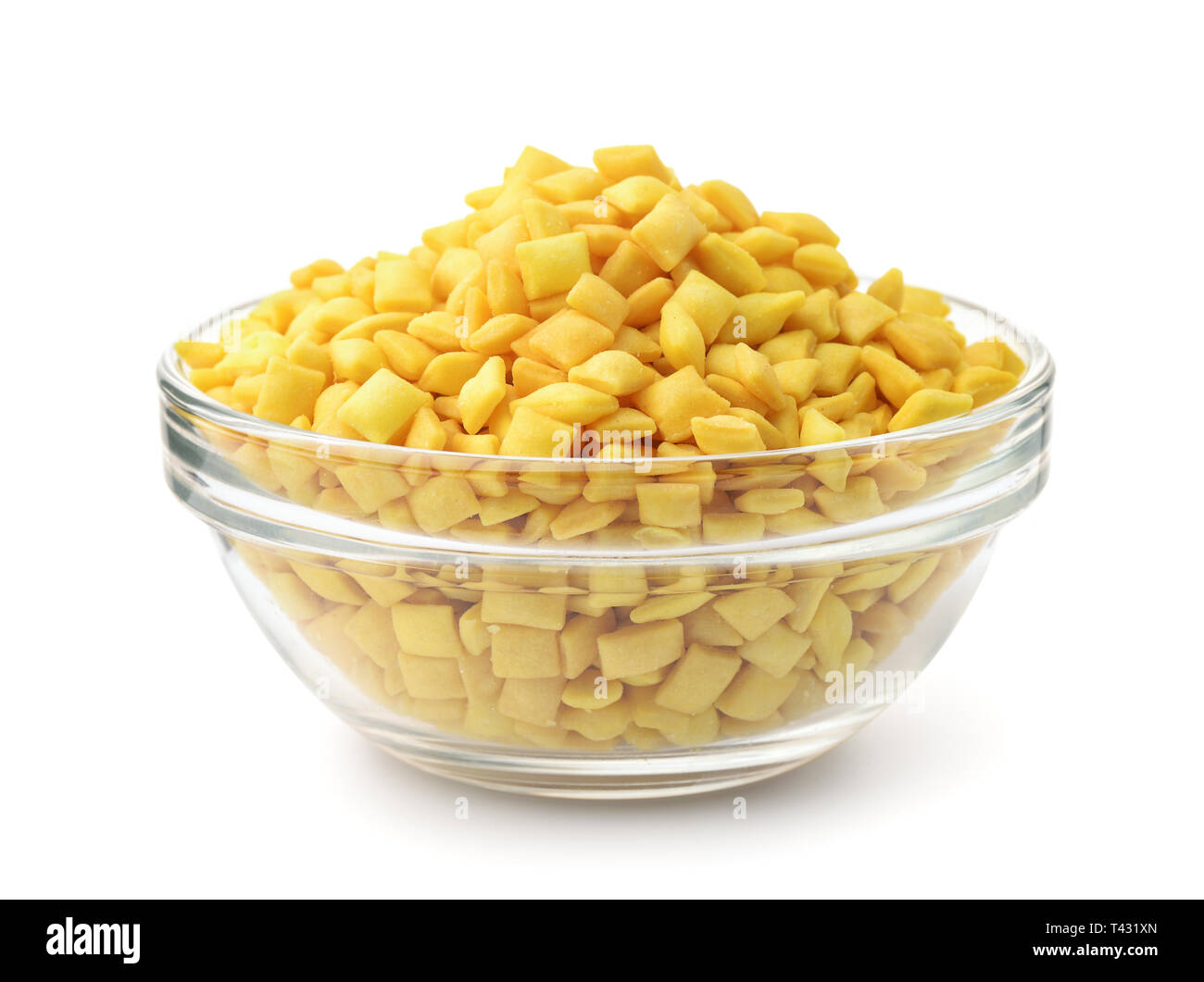 Glass bowl full of mini mandels croutons isolated on white Stock Photo