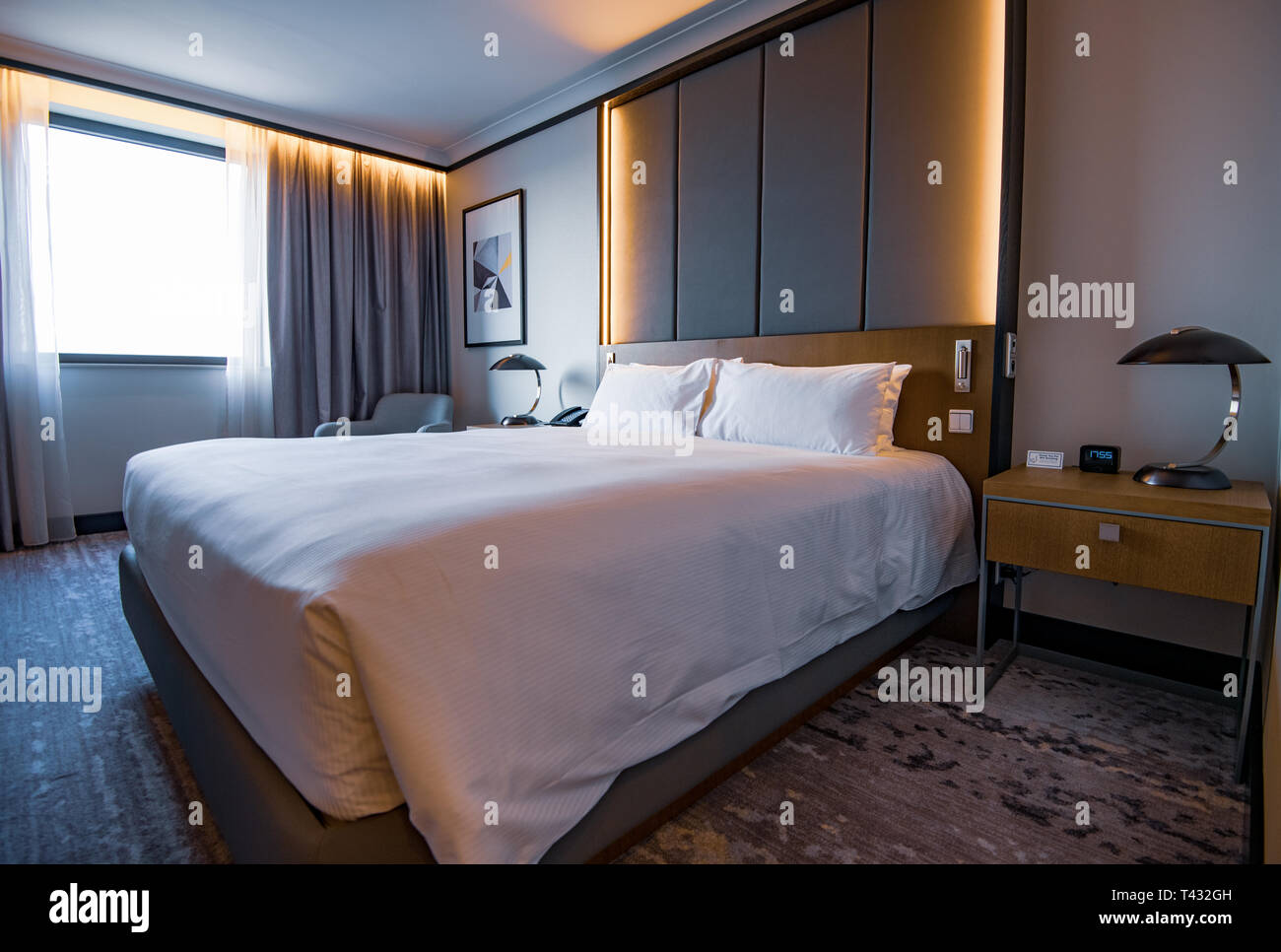 PRAGUE, CZECHIA - 9TH ARPIL 2019: Pictures of a generic hotel room - Bed, window, table, lamps all in shot. Stock Photo
