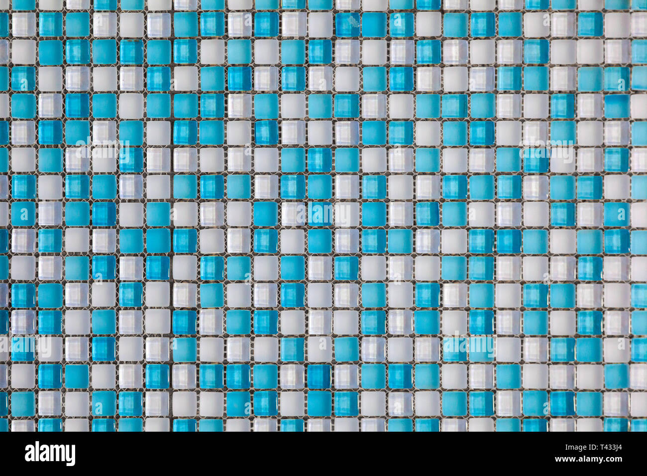 Blue and white colored mosaic background tiles. Close up cleaning blue