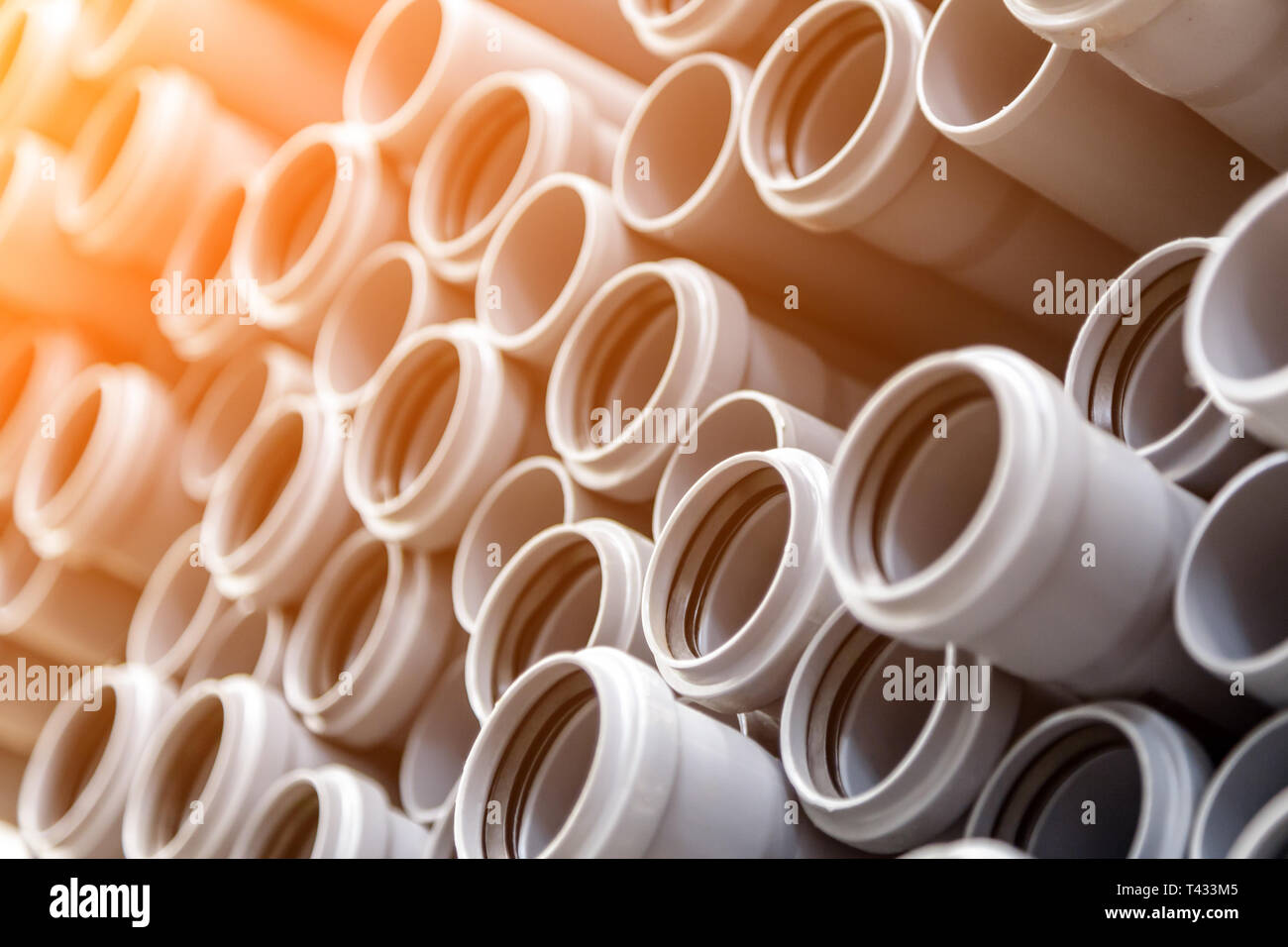 Close up gray plumbing plastic pipes. Background of colorful big