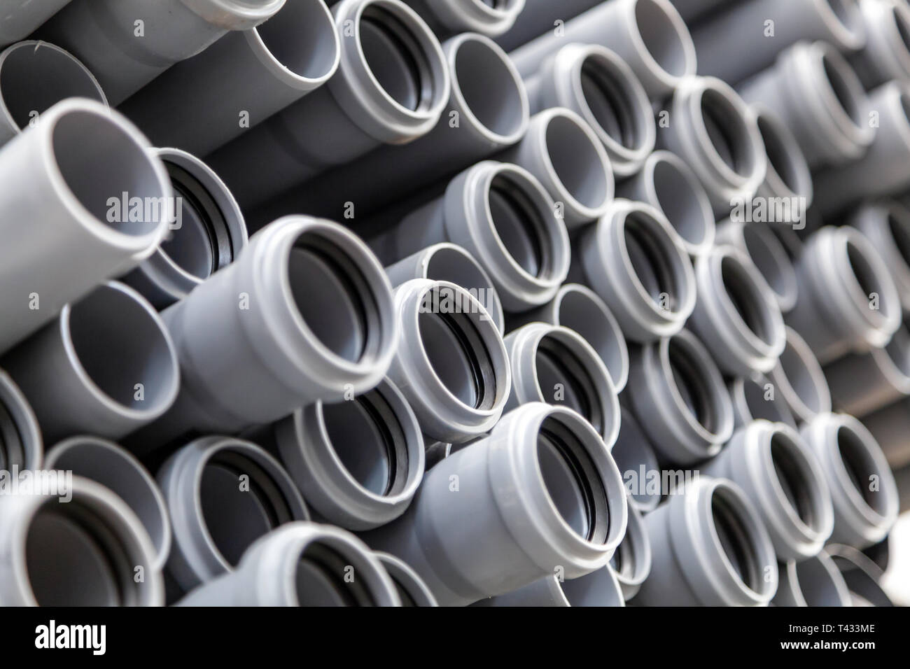 Close up gray plumbing plastic pipes. Background of colorful big