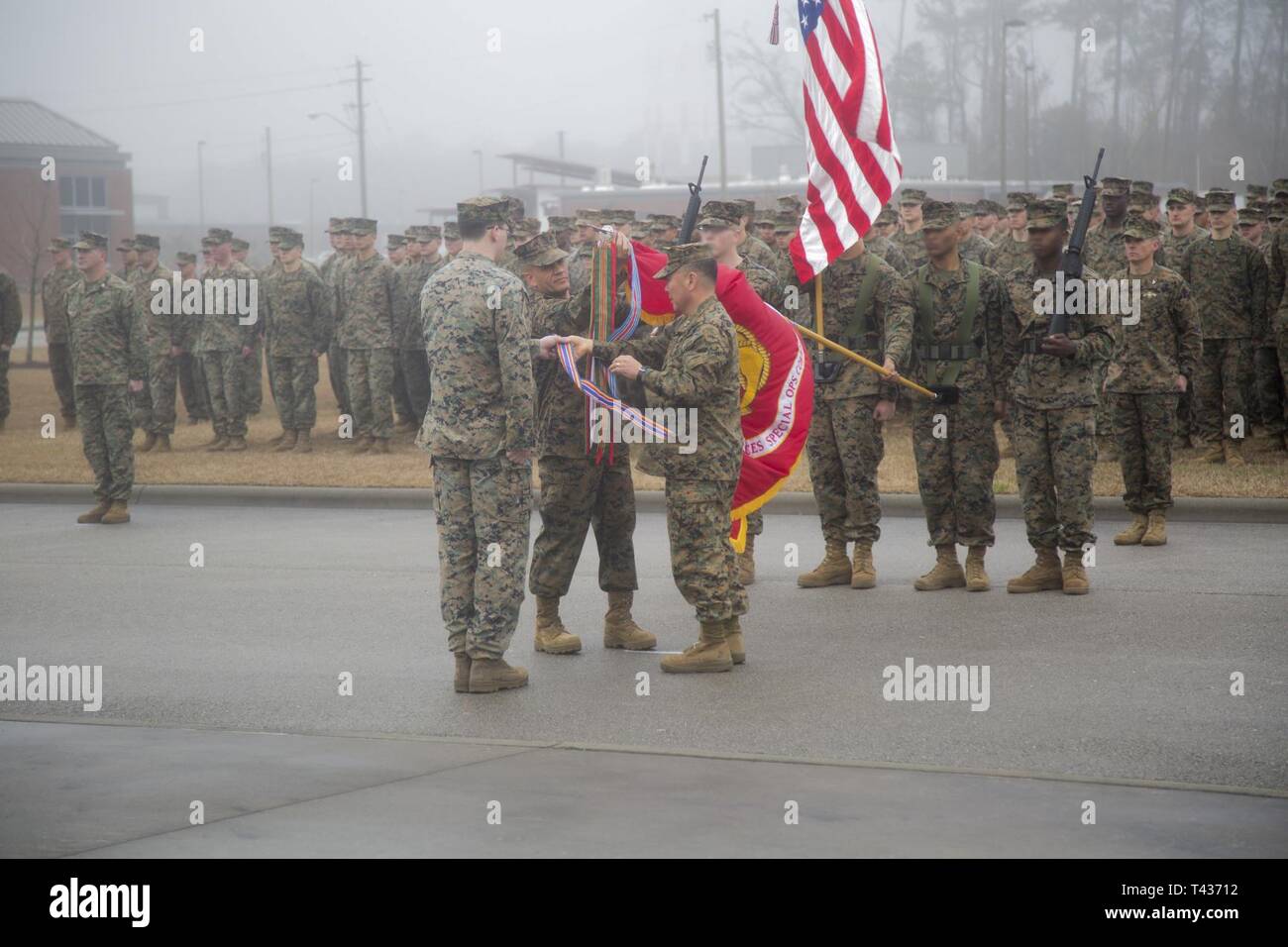 Commander, U.S. Marine Corps Forces, Special Operations Command, Maj. Gen. Daniel D. Yoo, and the command’s sergeant major, Sgt. Maj. Rafael Rodriguez, secure awarded streamers to the organizational battle colors during MARSOC’s 13th Anniversary Ceremony at Marine Corps Base Camp Lejeune, N.C., February 21, 2019. Yoo also recognized Marines and Sailors for their exemplary performance. Since the unit’s inception, Raiders, a name adopted in 2015 in recognition of their forbearers, have earned more than 300 valor awards. Stock Photo