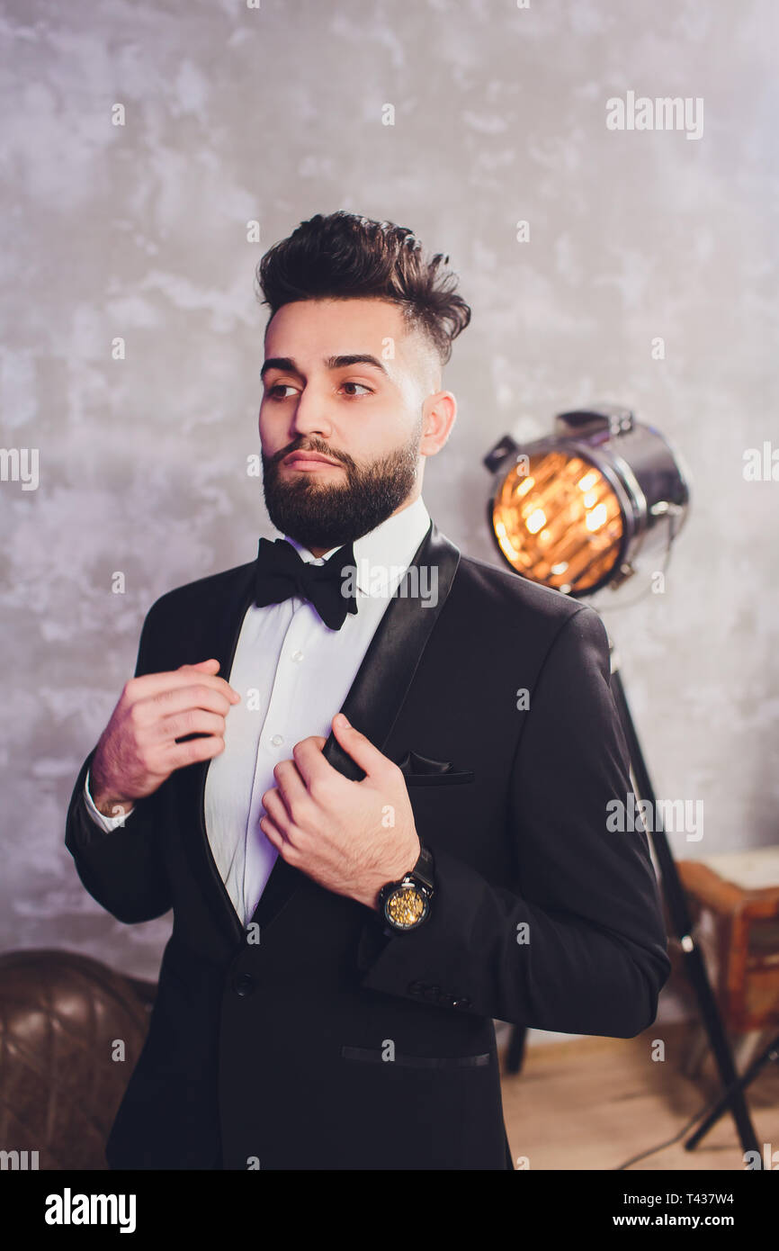 Portrait of handsome stylish man in elegant black suit Stock Photo - Alamy