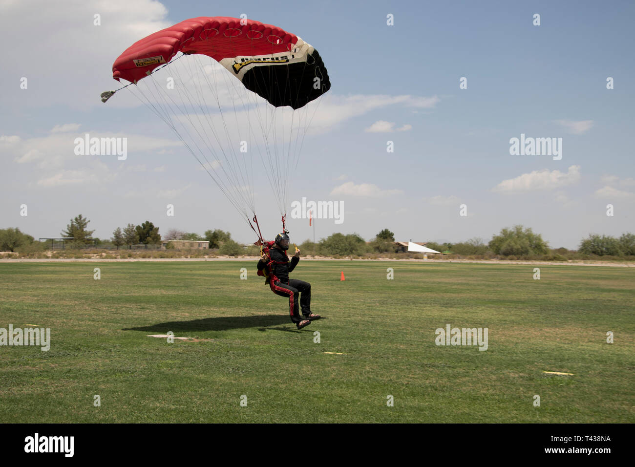 Man flying parachute after sport skydiving. Close up of skydiver flying parachute in the summer. Stock Photo