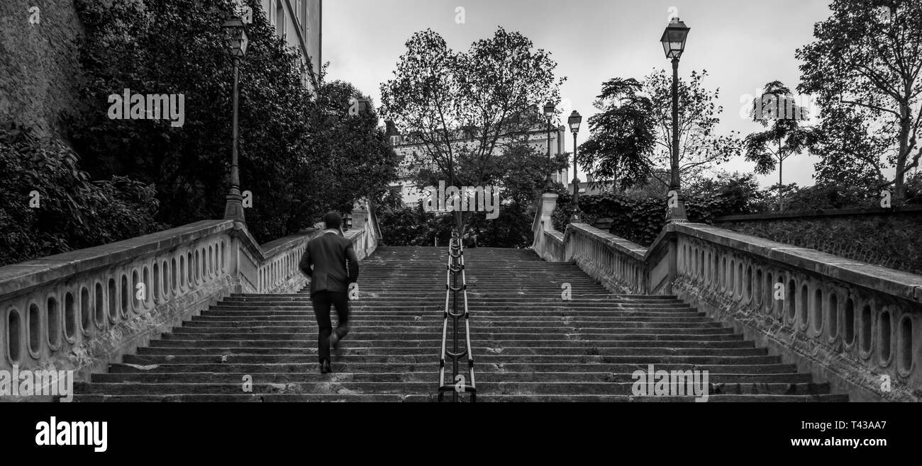 Cityscape of a man climbing stairs in Paris Stock Photo