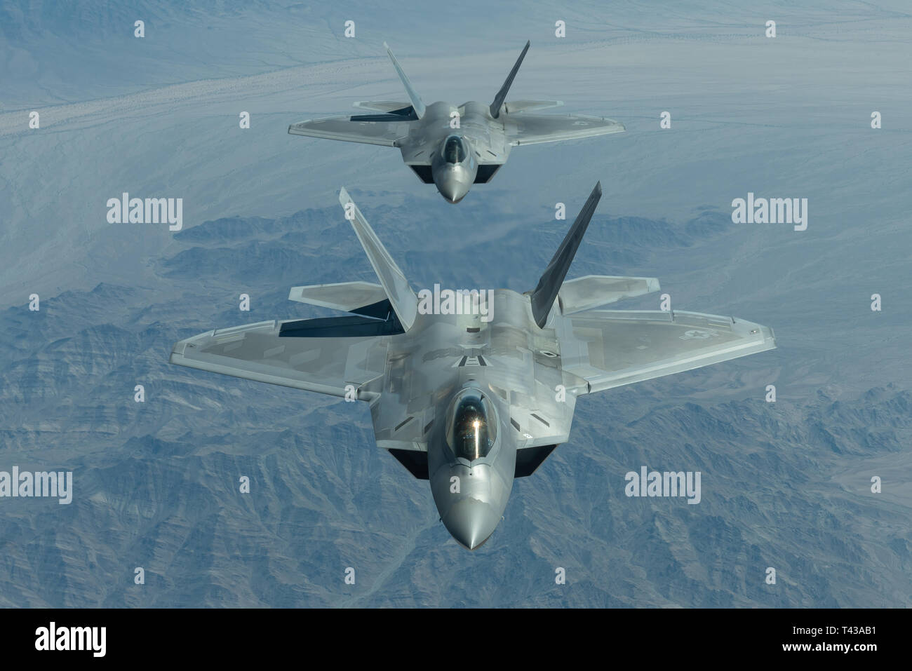 U.S. Air Force Maj. Paul 'Loco' Lopez, F-22 Demo Team pilot/commander, and 1st Lt. Cory Clark, F-22 Demo Team safety observer, fly in formation over the skies of Northern California while en route to Travis Air Force Base for the Thunder Over the Bay air show March 25, 2019. Both Maj. Lopez and 1st Lt. Clark received fuel along the way from a KC-10 Extender attached to the 9th Air Refueling Squadron out of Travis AFB. (U.S. Air Force photo by 2nd Lt. Samuel Eckholm) Stock Photo