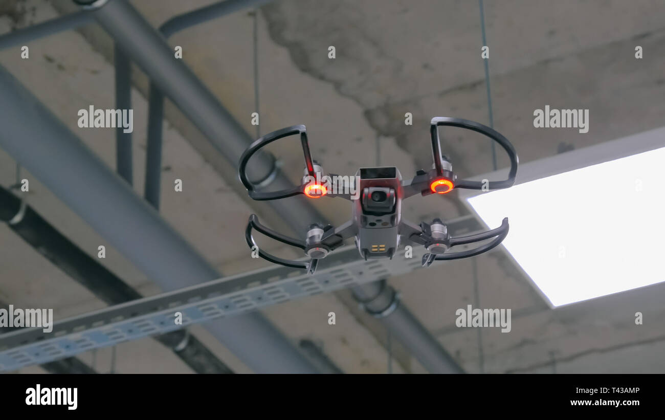 Drone with red light flying indoor Stock Photo
