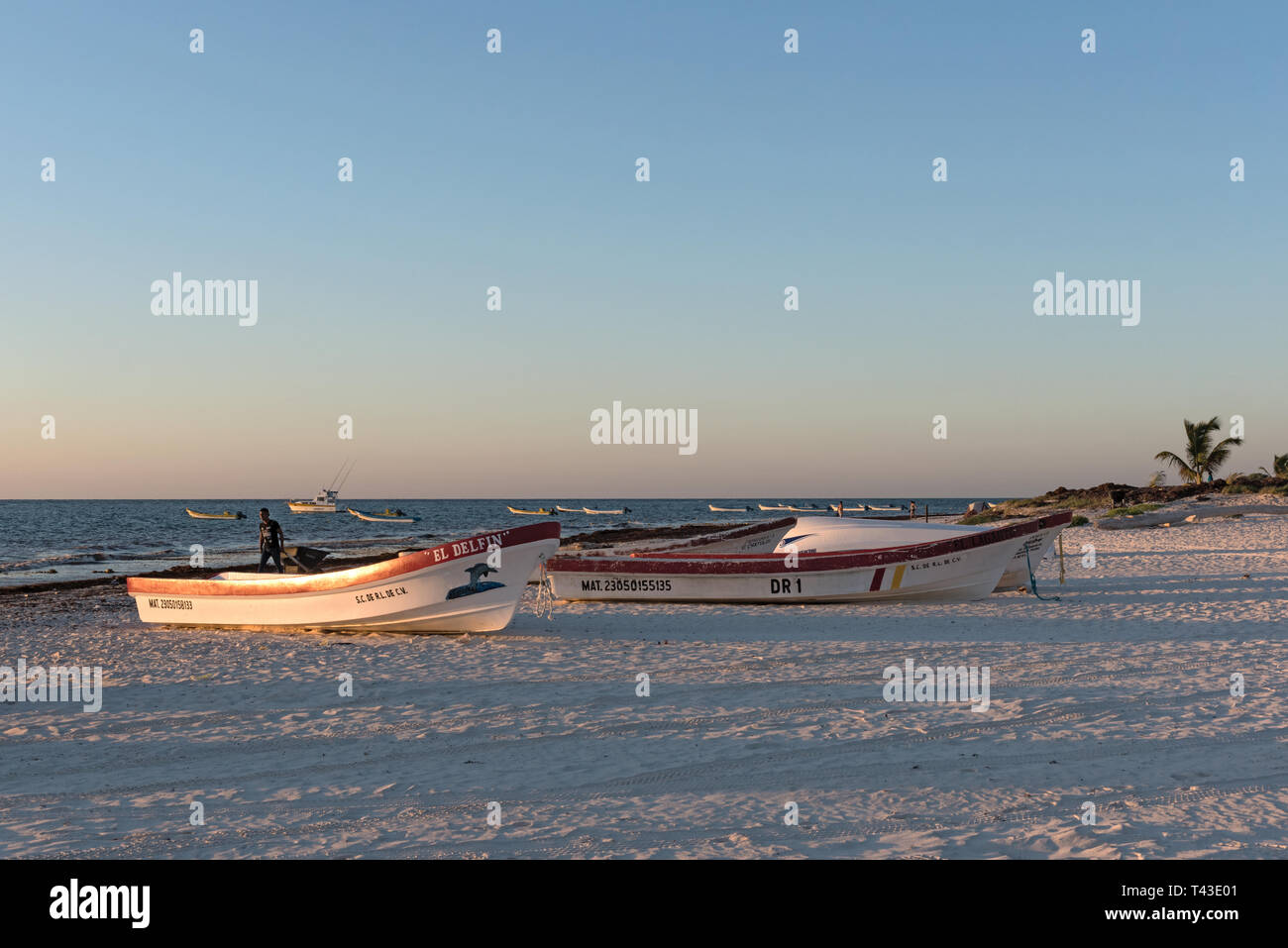 fishing boats at sunrise at playa pescadores in tulum mexico Stock Photo