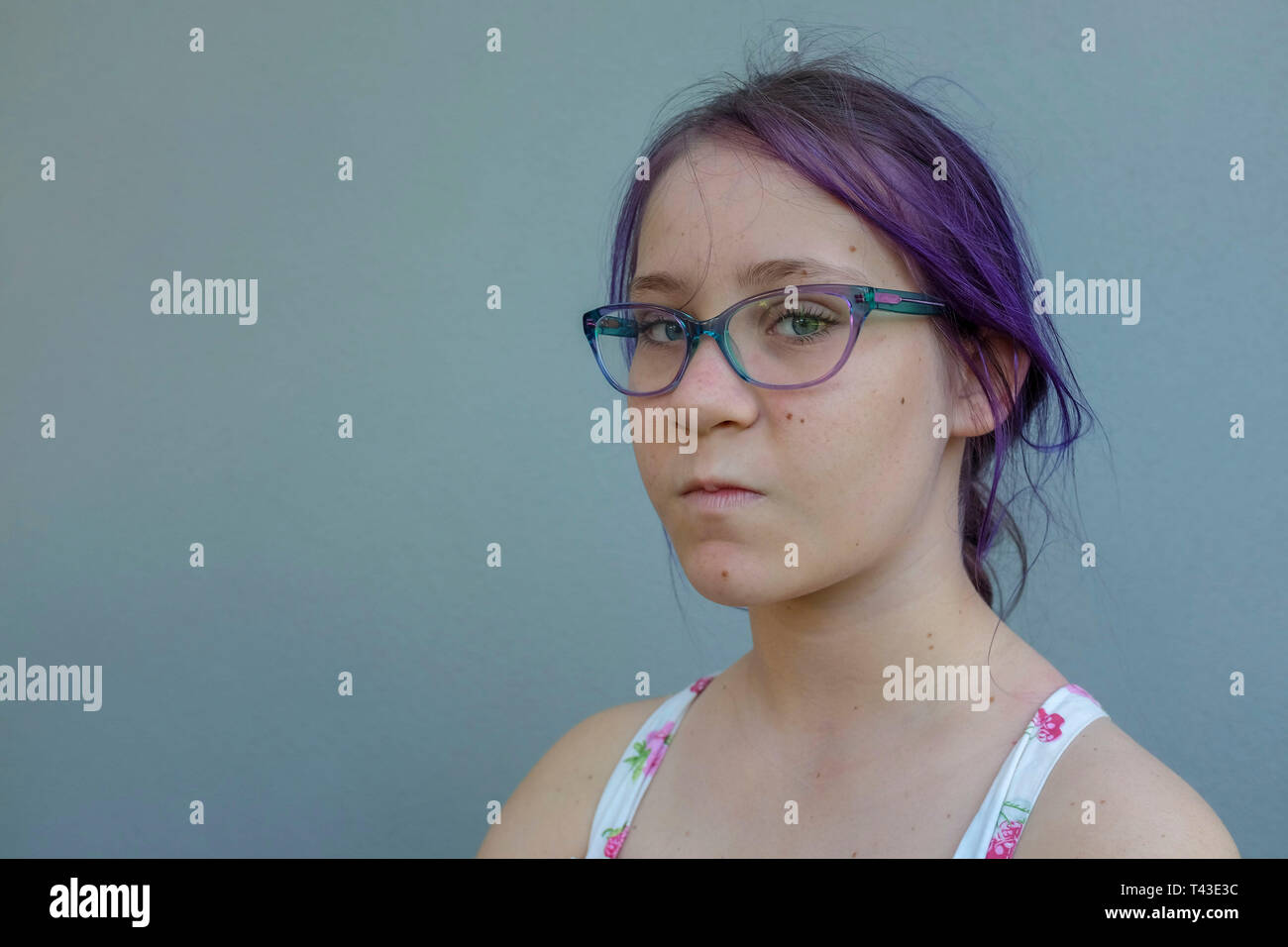Portrait of a teenage girl with purple hair and prescription glasses and attitude against a grey wall Stock Photo - Alamy Portrait of a teenage girl with purple hair and prescription glasses and attitude against a grey wall Stock Photo - Alamy