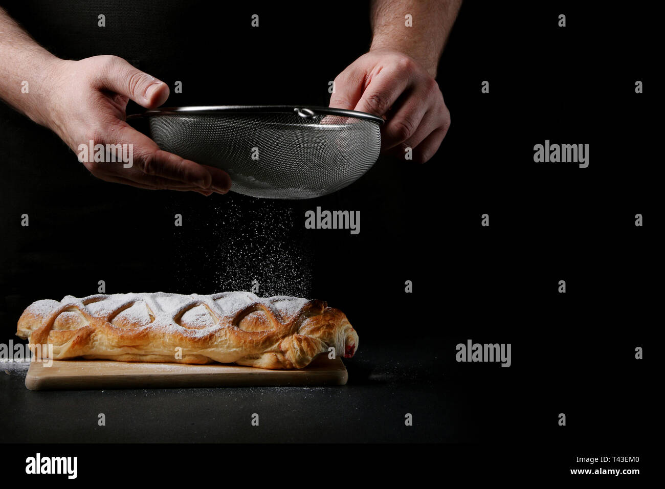 baker decorating on dark background. recipe concept. Stock Photo