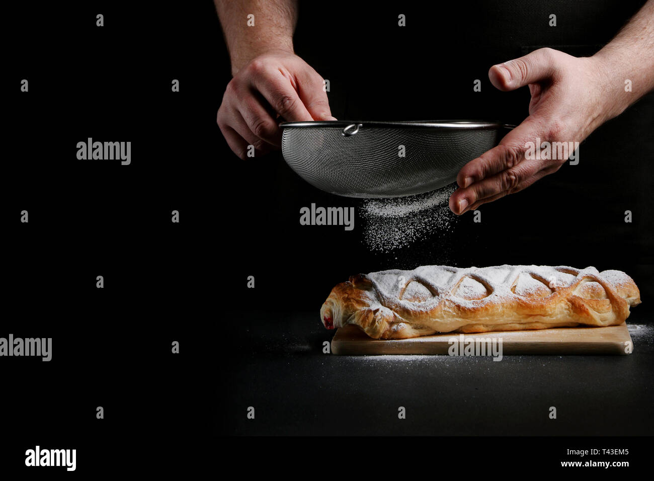 baker decorating on dark background. recipe concept. Stock Photo
