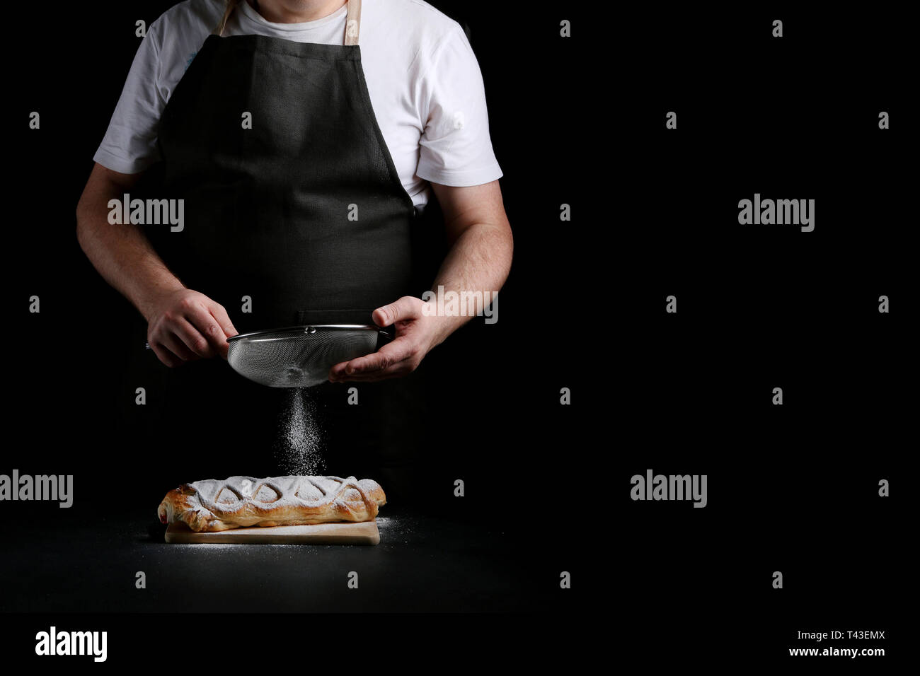 baker decorating on dark background. recipe concept. Stock Photo
