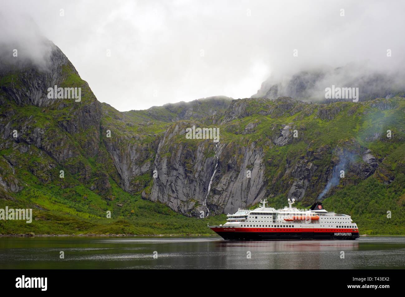 Cruising the Lofoten islands - Hurtigruten famous Norwegian cruise, ferry and cargo company operating voyages on Norway's western and northern coast Stock Photo