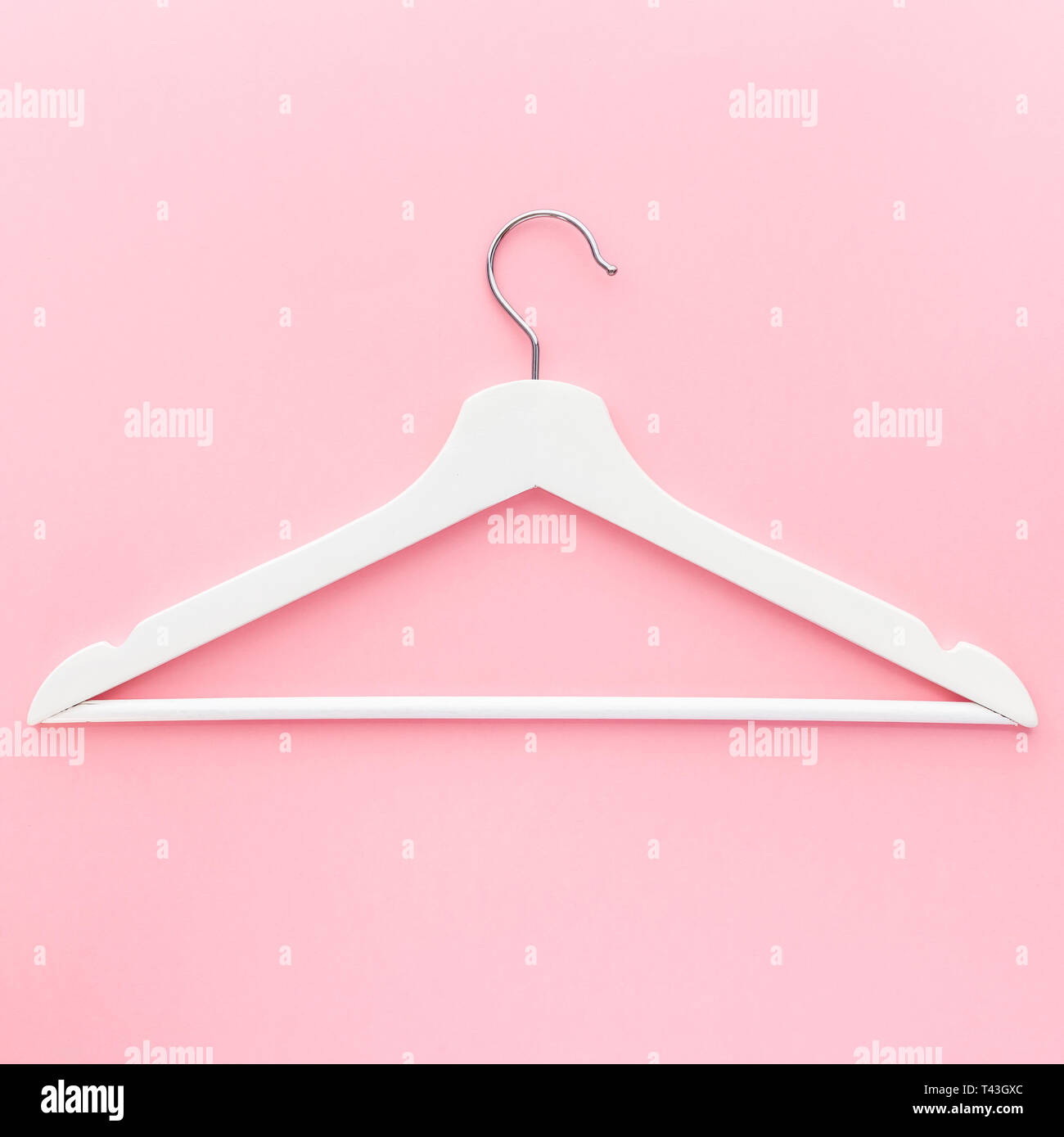 Creative top view flat lay white wooden hangers pastel millennial pink ...