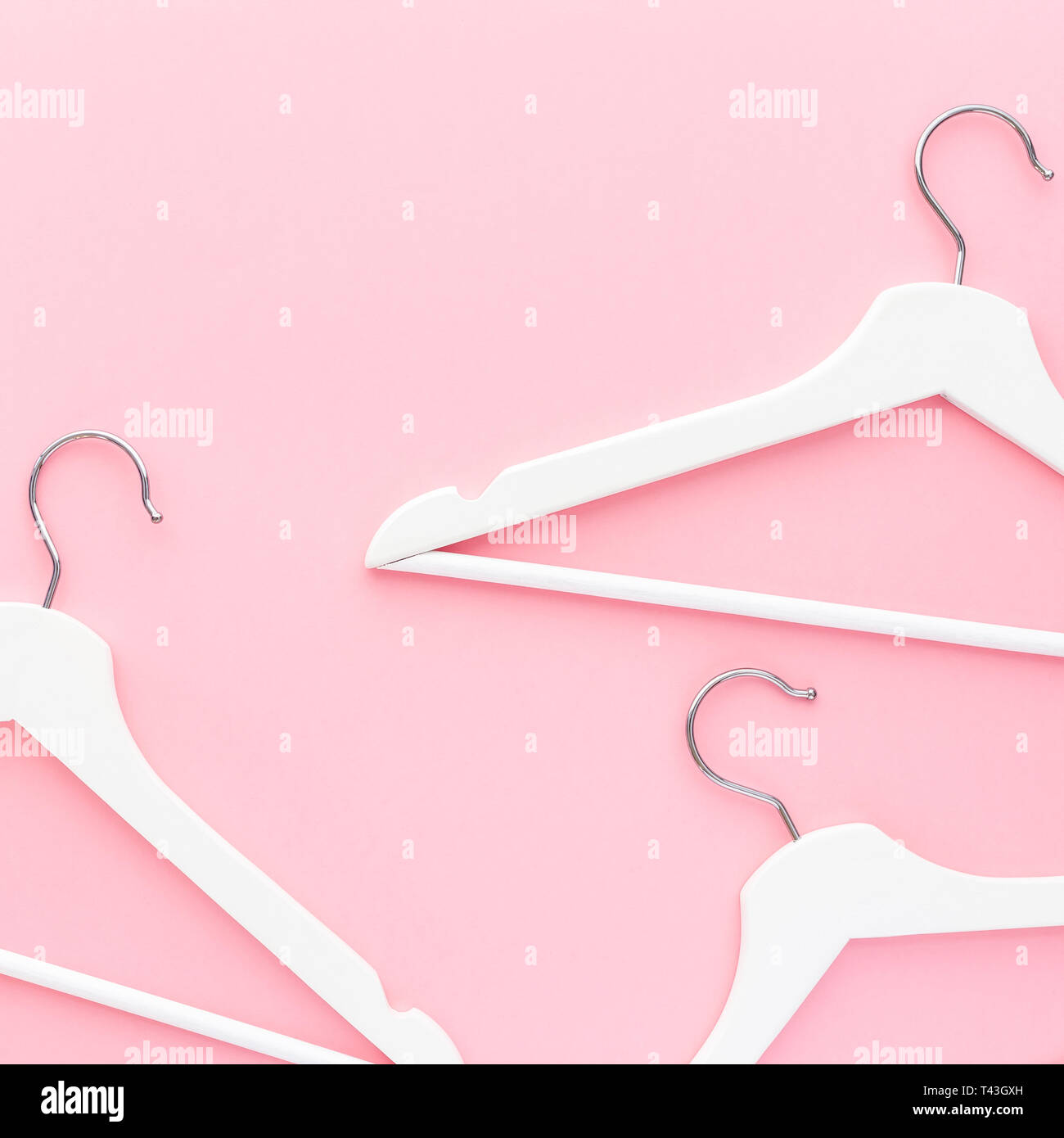 Creative top view flat lay white wooden hangers pastel millennial pink ...