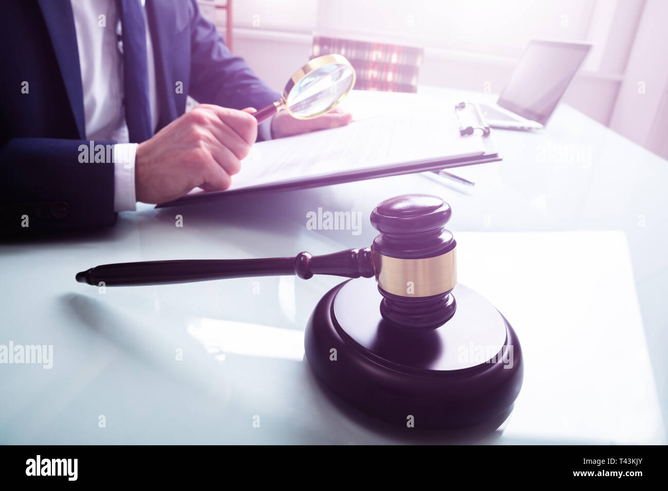 Male Justice Working On Legal Documents With Gavel In The Courtroom Stock Photo