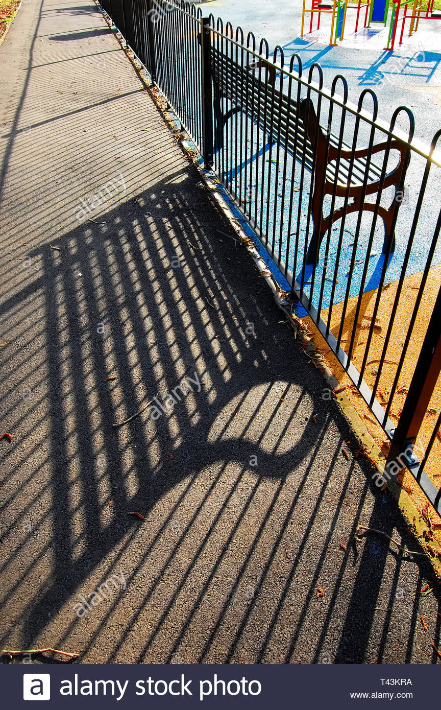Sillhouted Restful Park Bench In Children S Play Area With Iron