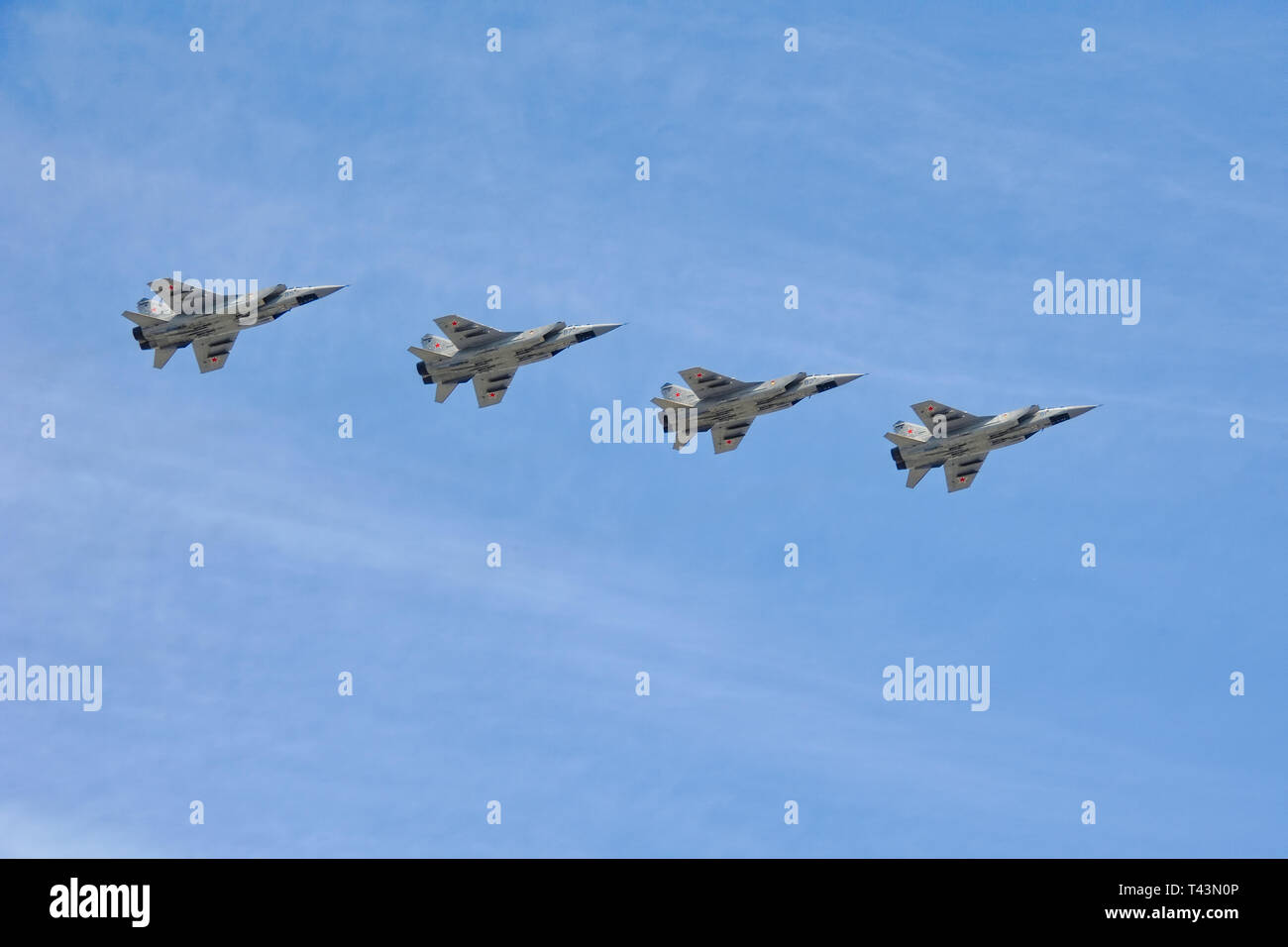 = Interceptor Aircrafts MiG-31 in the Sky over Red Square =  Four Russian long-range supersonic interceptor aircrafts MiG-31 Foxhound flying in format Stock Photo