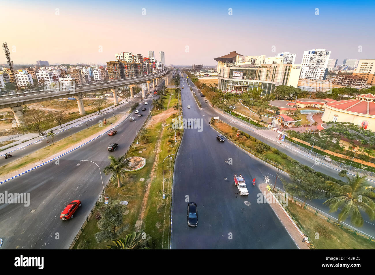 India city aerial view with highway road residential and commercial buildings with view of over bridge and city traffic at sunset Stock Photo