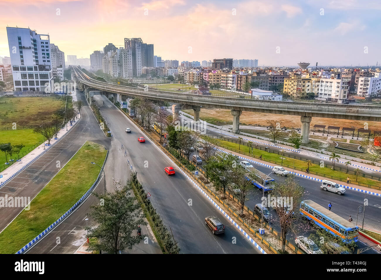 Indian city aerial view with highway road residential and commercial buildings with view of over bridge and city traffic at sunset Stock Photo