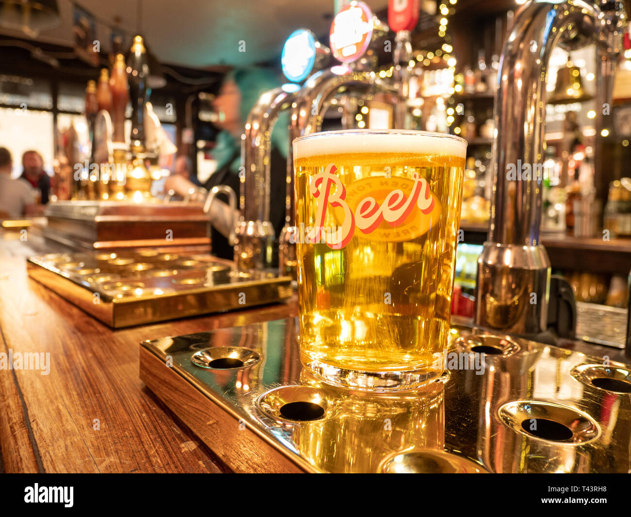 Pint of lager on pub bar, UK Stock Photo