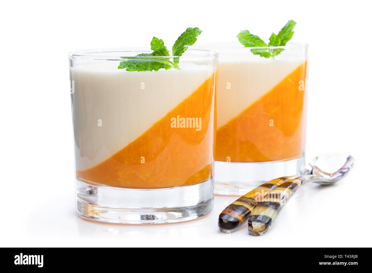 Panna  cotta with orange jelly in clear glass isolated on white Stock Photo
