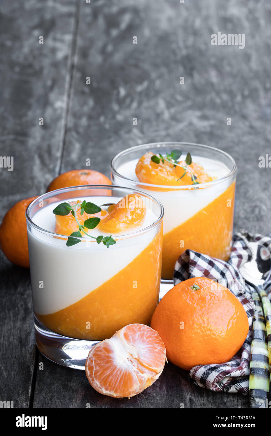 Panna cotta with mandarine jelly in clear glass on wooden table Stock Photo  - Alamy