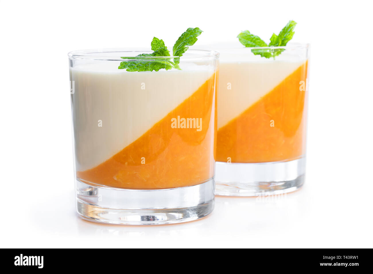 Panna  cotta with orange jelly in clear glass isolated on white Stock Photo