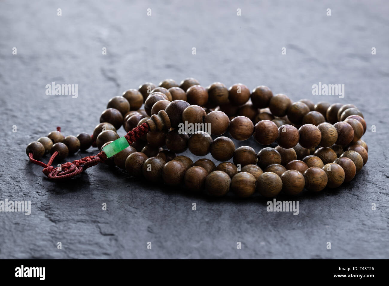 Female Hand Holding a Buddhist Japa Mala Made from 108 Natural