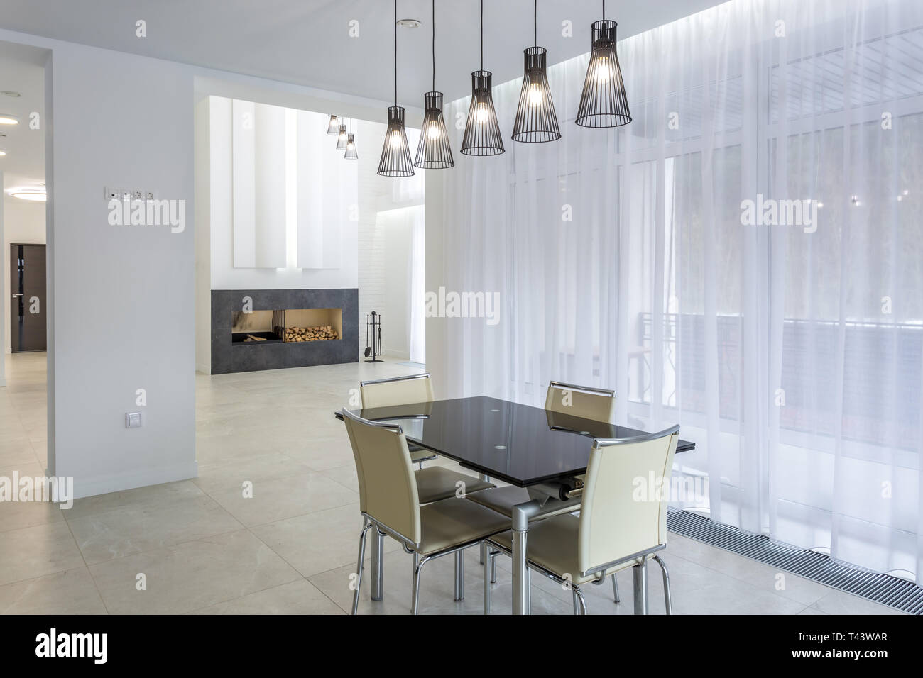 a range of fashionable lamps with dinner table in bright interior loft Stock Photo