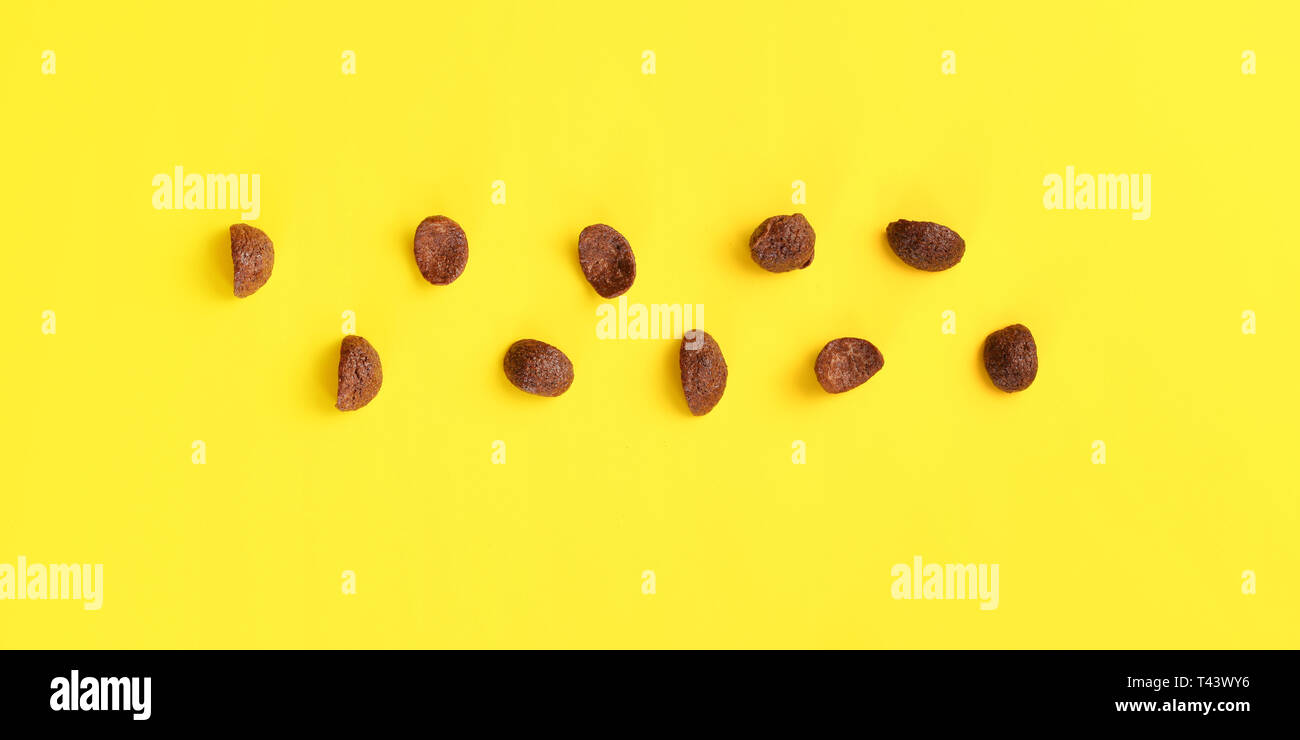 Top down view, chocolate cornflakes on yellow board. Stock Photo
