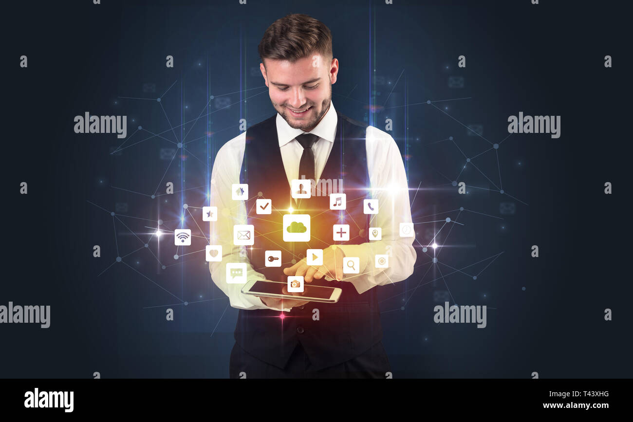 Handsome businessman in suit with tablet on his hand and application ...