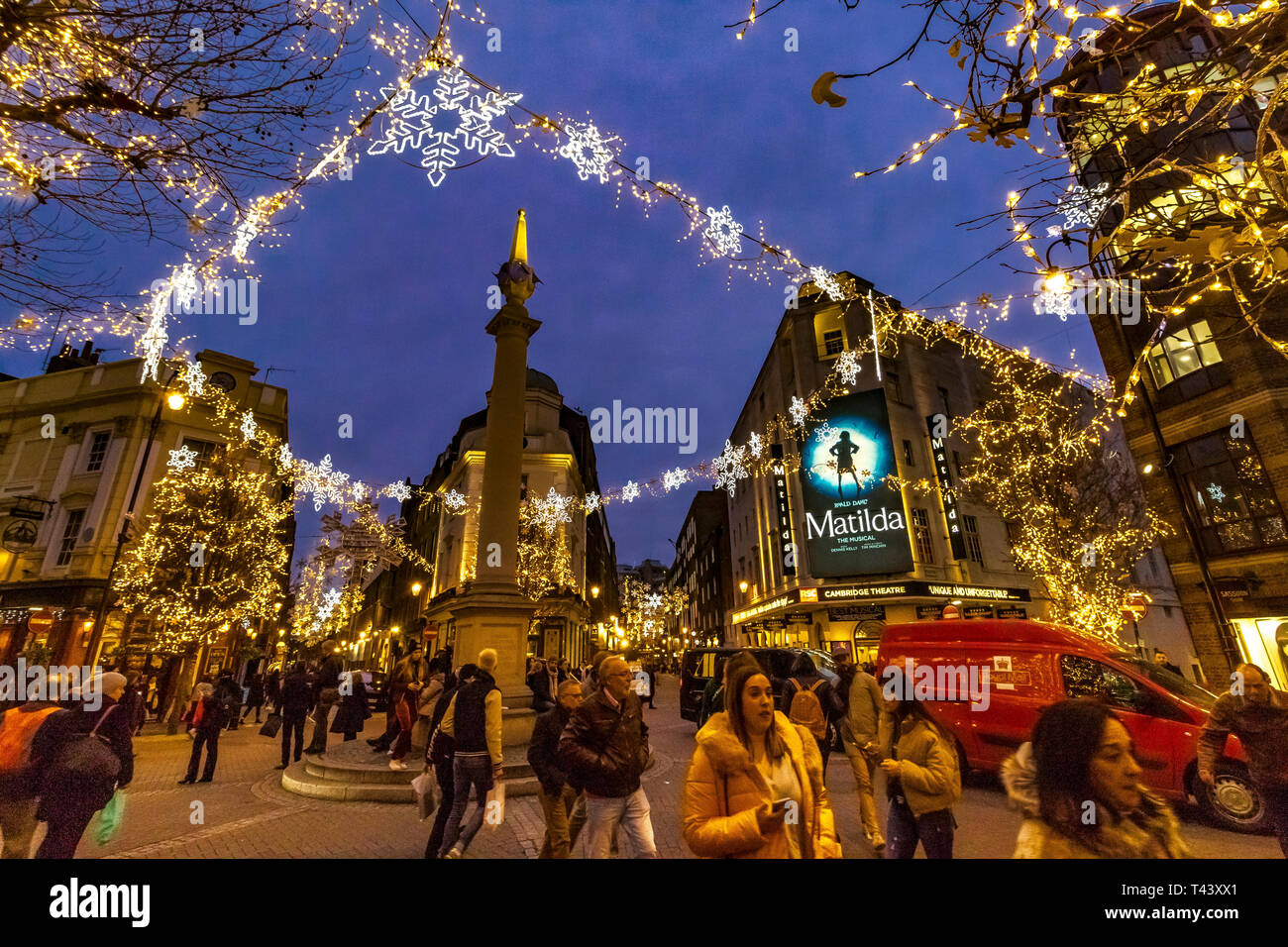 Shoppers and visitors walking in the busy streets of  Seven Dials at Christmas, London, UK Stock Photo
